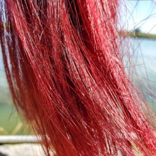 dyed red hair blowing in the wind